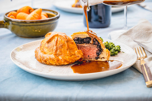 individual beef wellington with gravy poured over