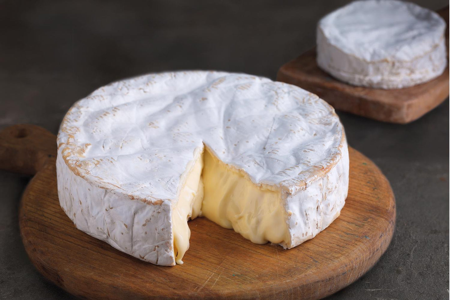 Baron Bigod British Brie Cheese Wheel on a wooden cutting board
