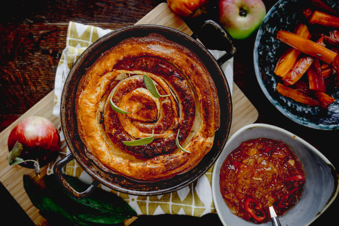 Cumberland Sausage curl toad in the hole next to roasted carrots