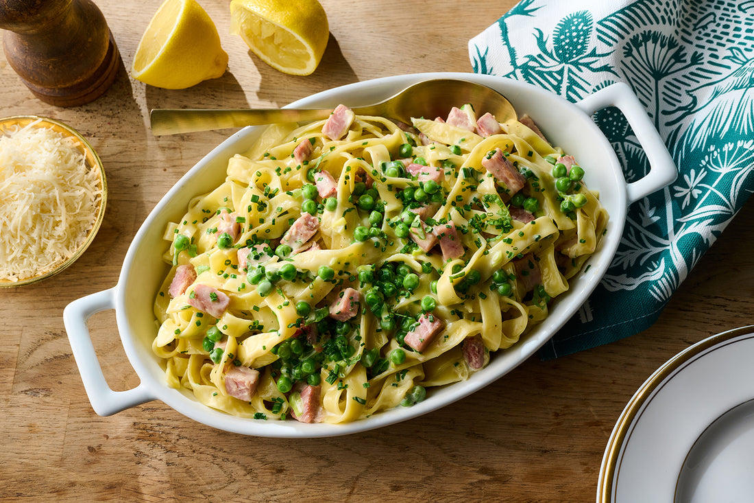 creamy diced ham tagliatelle in a serving dish