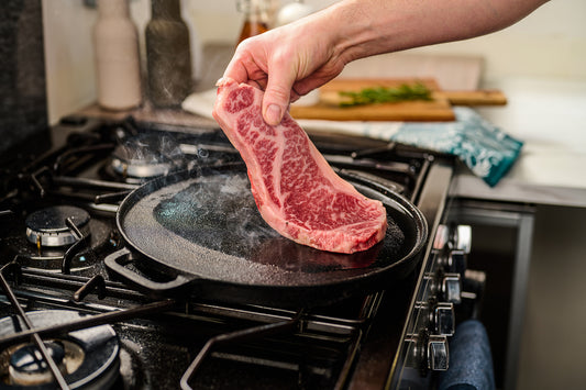 wagyu steak being cooked in pan