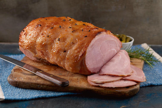 large ham on wooden board