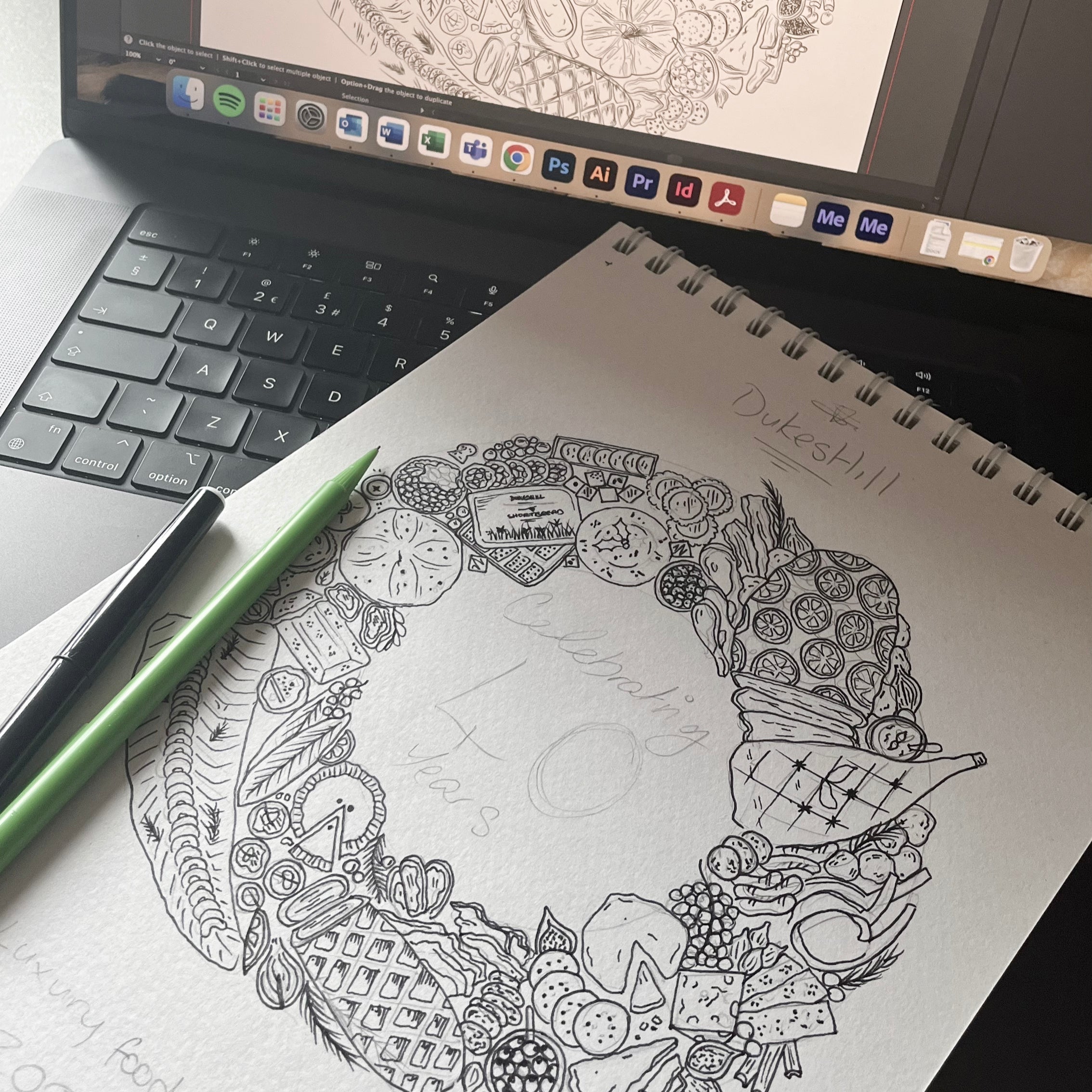 Coloring book page with intricate design next to a computer screen displaying the same design.