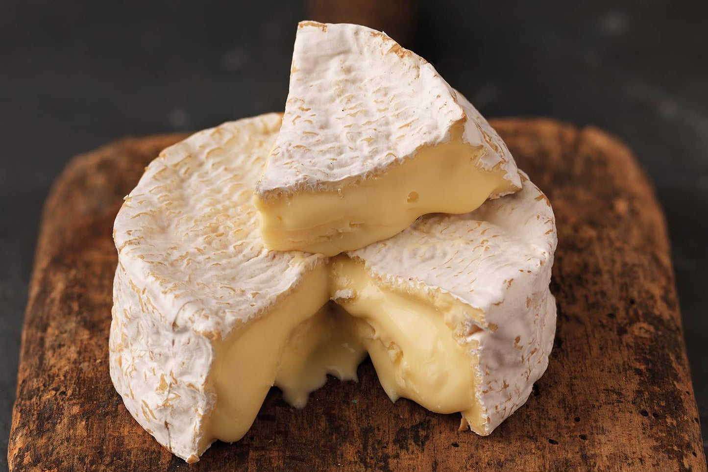 Baron Bigod British Brie Cheese Wheel with a wedge cut out and placed on top